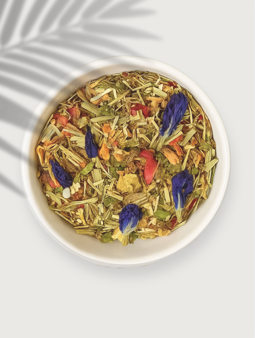 Herbal tea mix with TURMERIC, ROSE, GINGER, LEMONGRASS, FOR INFLAMMATION in a white bowl on a light background