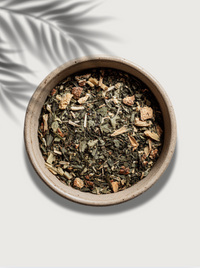 Dry hormone balance herbs and leaves in a ceramic bowl on a light background